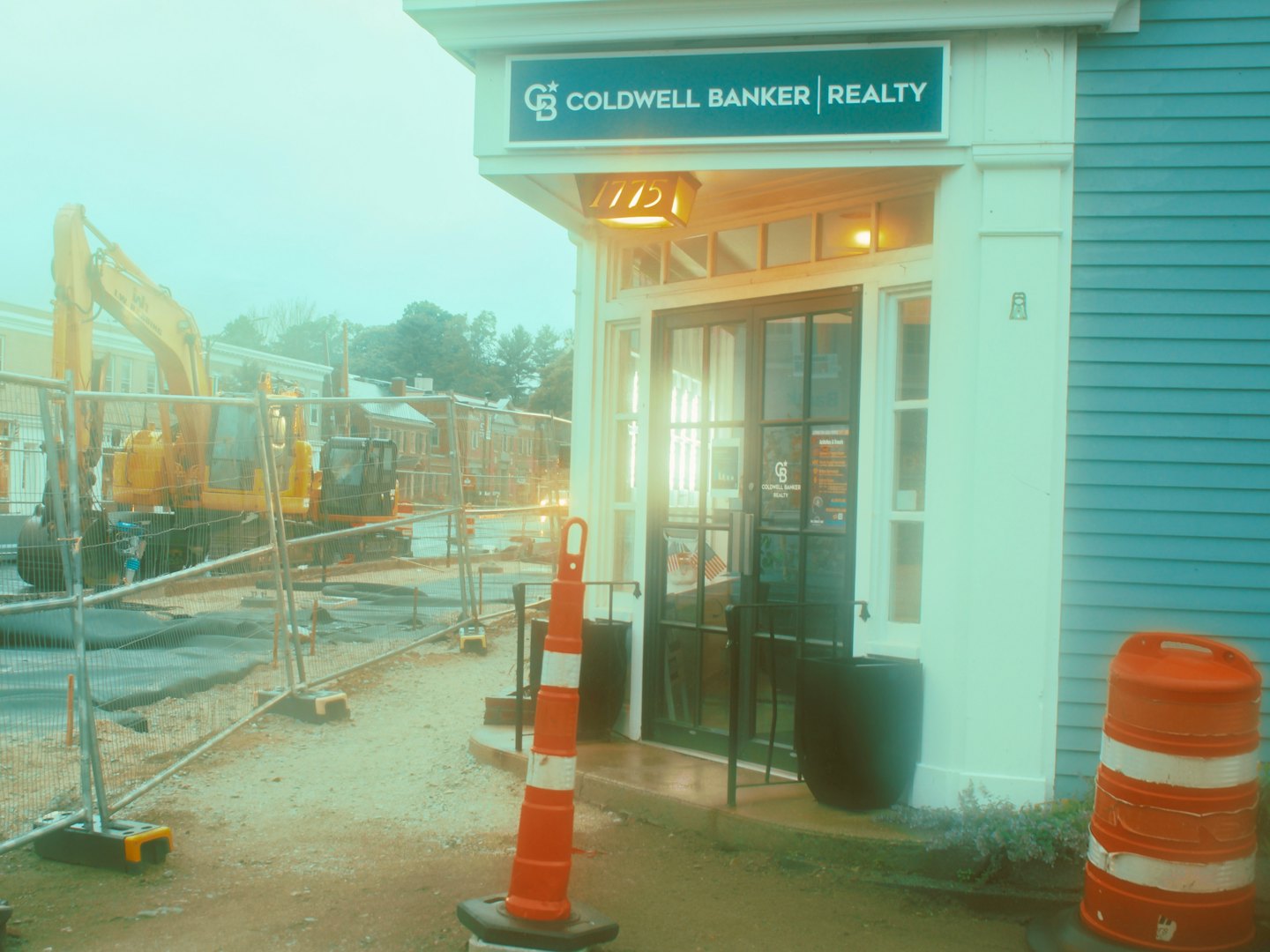 Coldwell Banker realty office building next to a construction site.